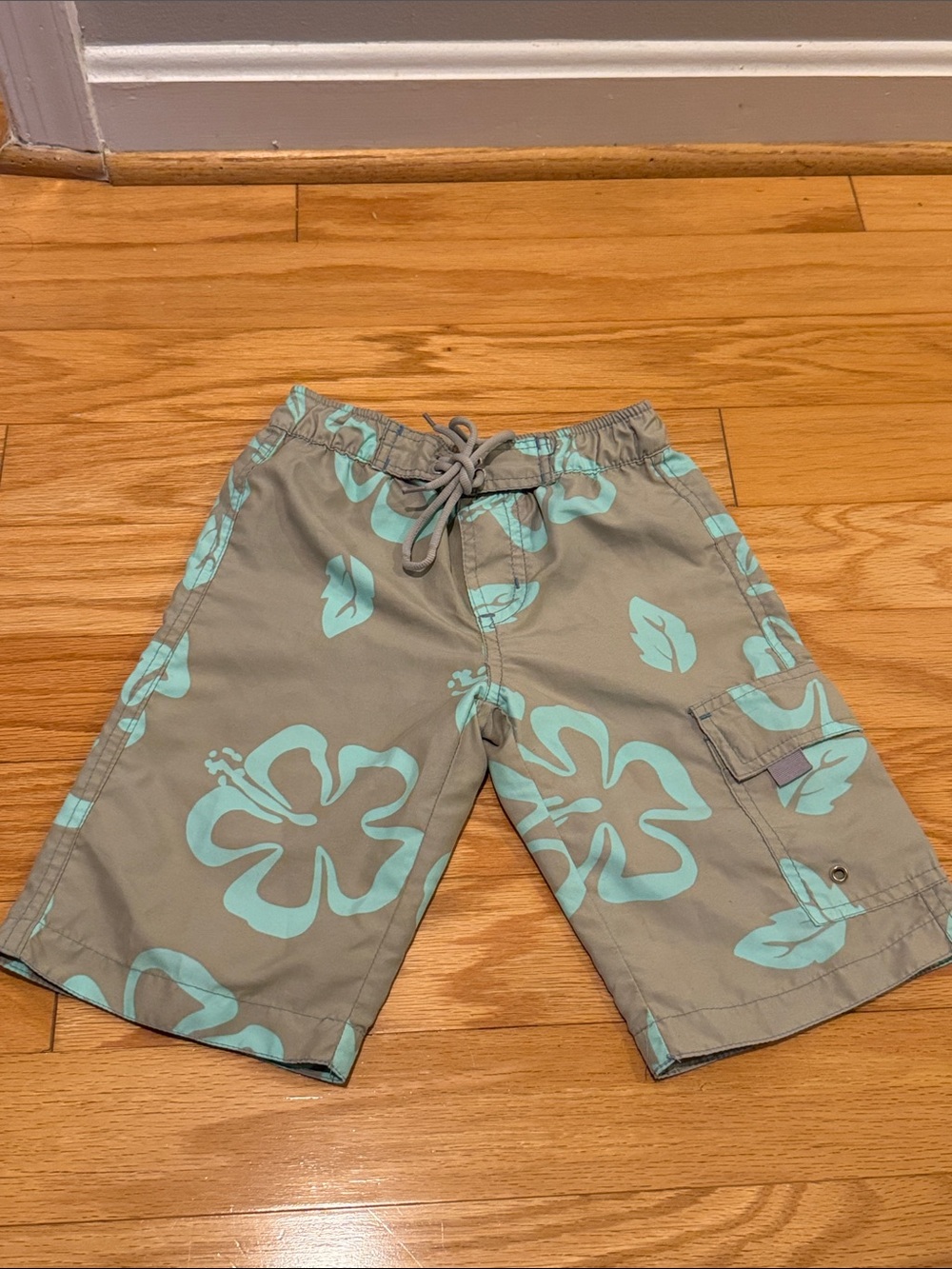 Gray khaki cargo board swim shorts with tropic flower leaf pattern and pockets